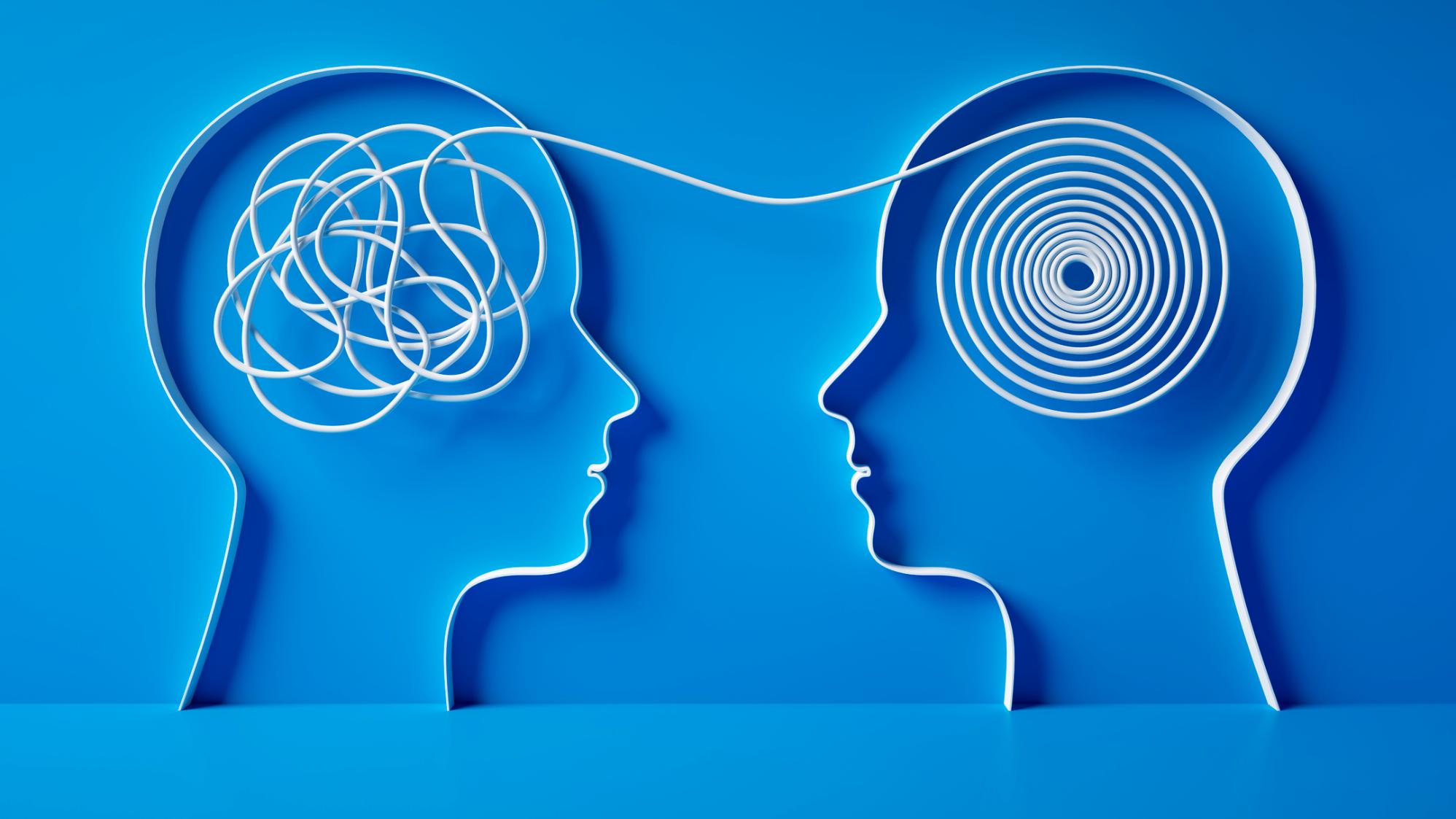 Two head silhouettes, one tangled and one ordered into a spiral